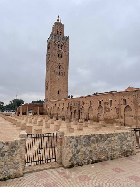       Tower and wall with intricate designs at a historical site
  