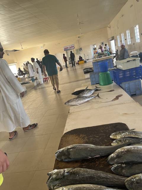       Interior of a fish market with various fish on display.
  