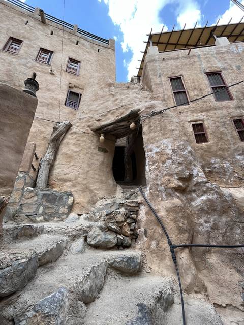       Traditional architecture with a stone building and clear blue sky.
  