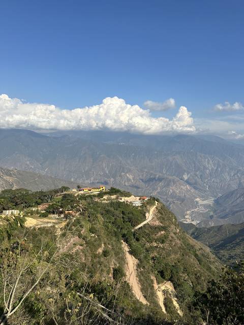 Mountainous landscape with a winding road.