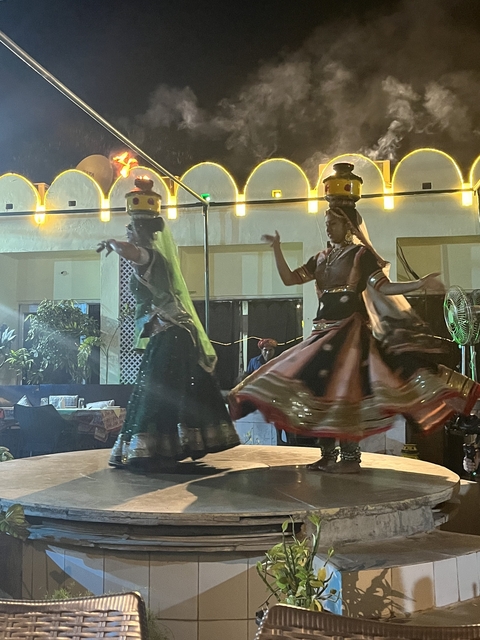 Two women dancing in traditional attire.