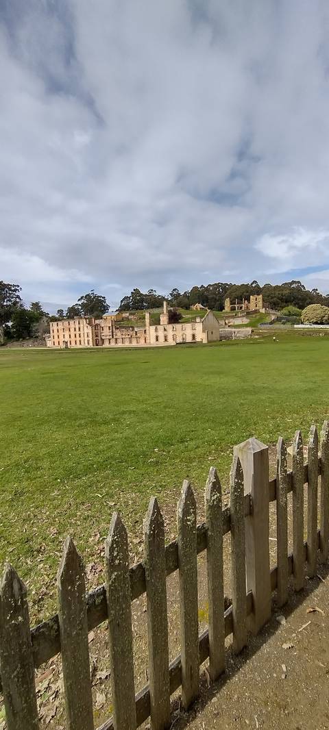 Historical buildings surrounded by green fields.