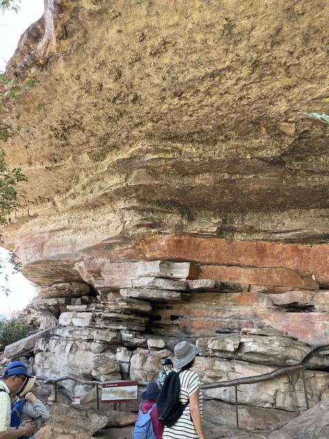 A tourist exploring rocky ancient ruins.