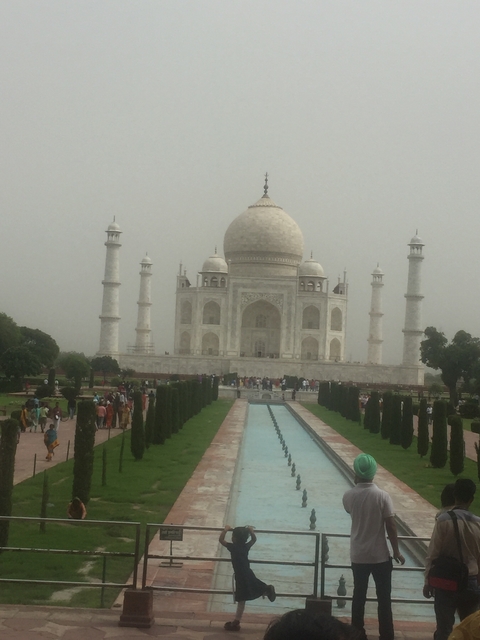 The Taj Mahal with people in the foreground.