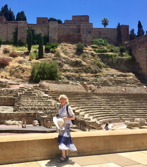 Person standing in front of ancient stone steps, likely part of a historical site.