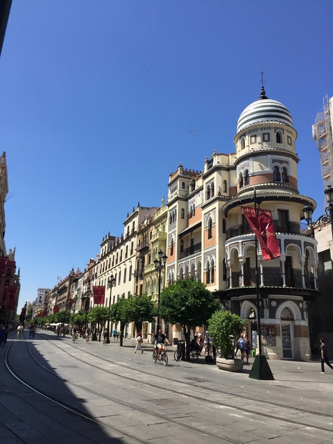       Street view with historical architecture and clear sky.
  