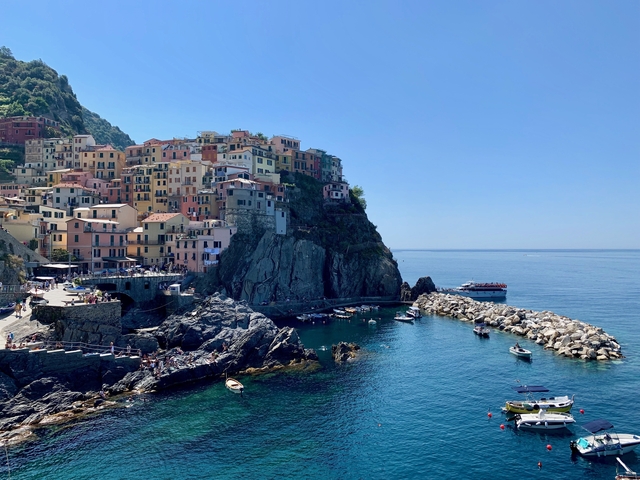 Cliffside town with colorful buildings overlooking the sea.
