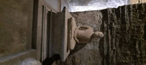       Stone statue in a cave setting.
  