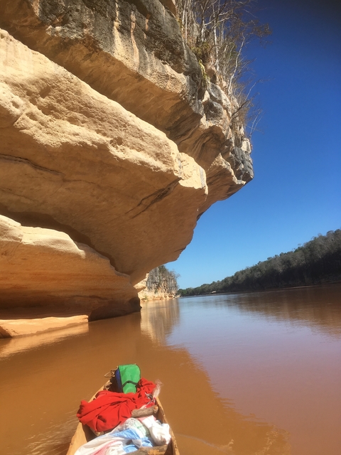 River landscape with overhanging rock formation.