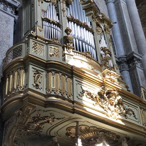       Ornate church organ with detailed decorations.
  