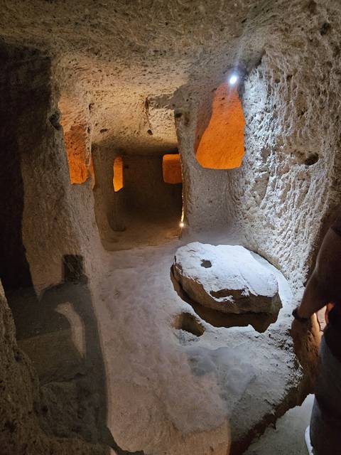       Underground narrow passage with dim lighting.
  