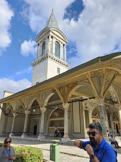       People near historic palace area.
  