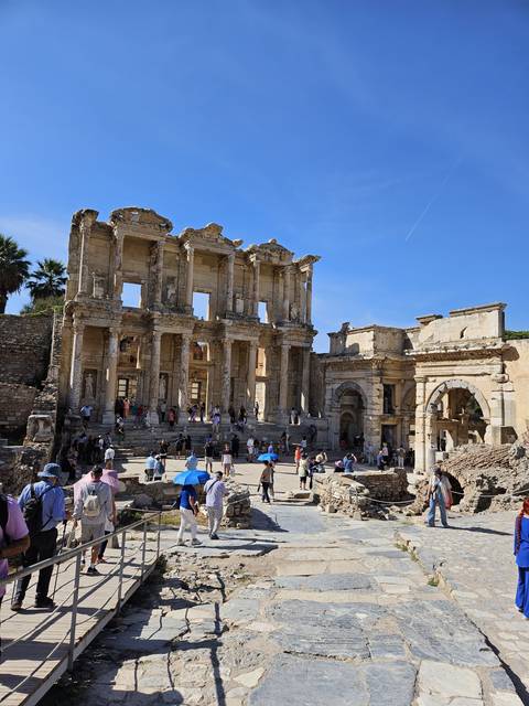       Ancient library with tourists visiting.
  
