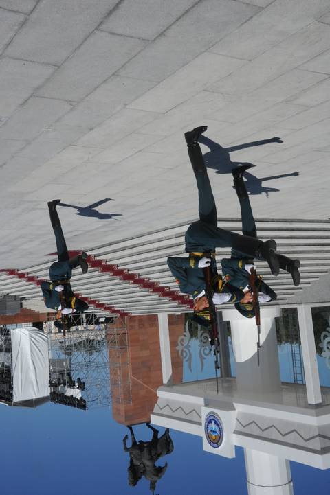 Guards marching in a ceremonial manner in a plaza