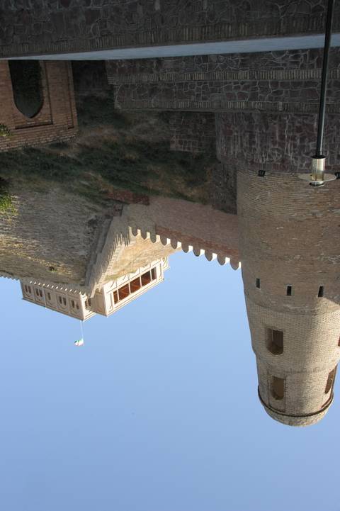 Historic fortress with a rugged wall and tower