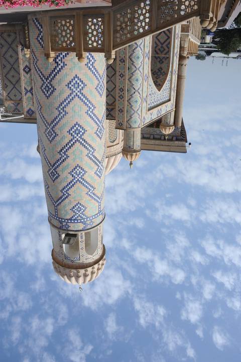 Beautifully patterned mosque with intricate details and blue sky
