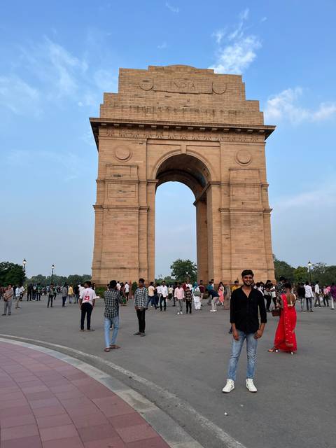 India Gate with people around it.