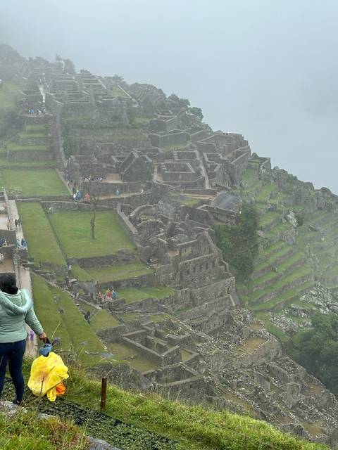 Foggy view of Machu Picchu terraces.
