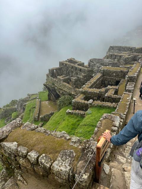 Cloudy view of Machu Picchu structures.