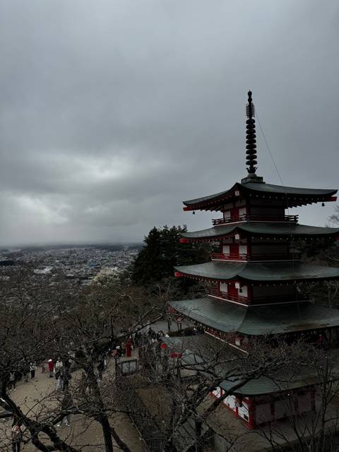 Pagoda with a view of a city and mountains.