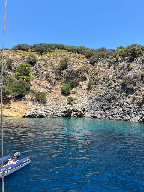       Rocky shoreline with clear blue water.
  