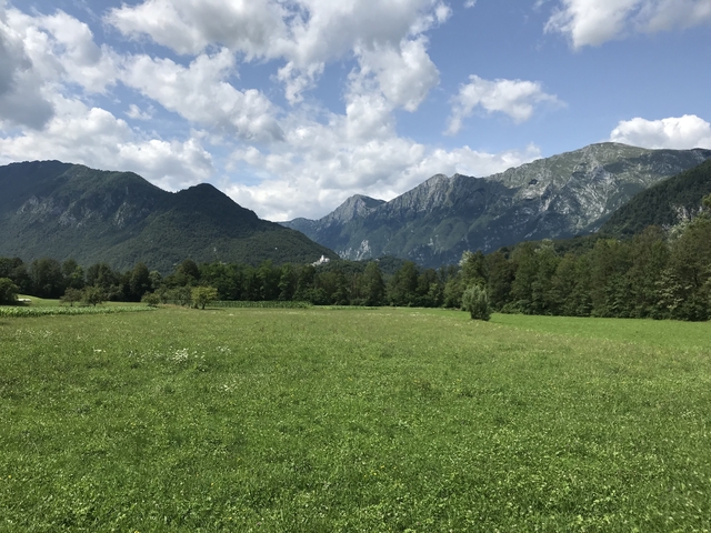       A picturesque view of mountains and a green valley.
  