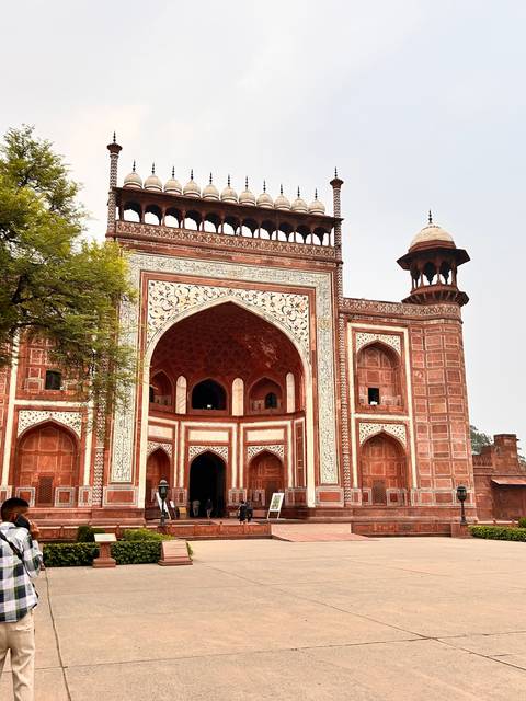       Main entrance of a historic building with a large arch.
  