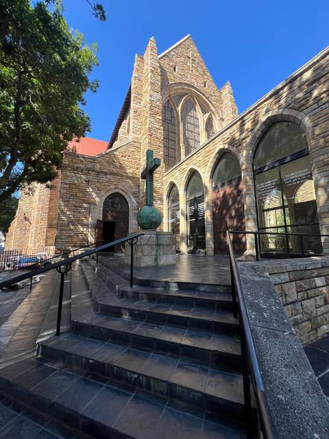 Exterior of a church with a staircase leading to it.