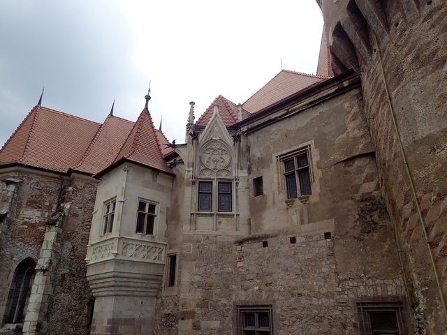 Historic castle with detailed stone architecture and red roofs.