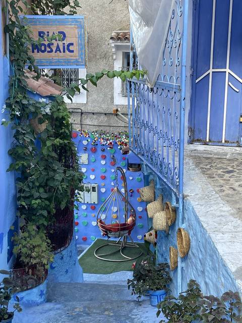 Colorful courtyard with decorative walls and plants.