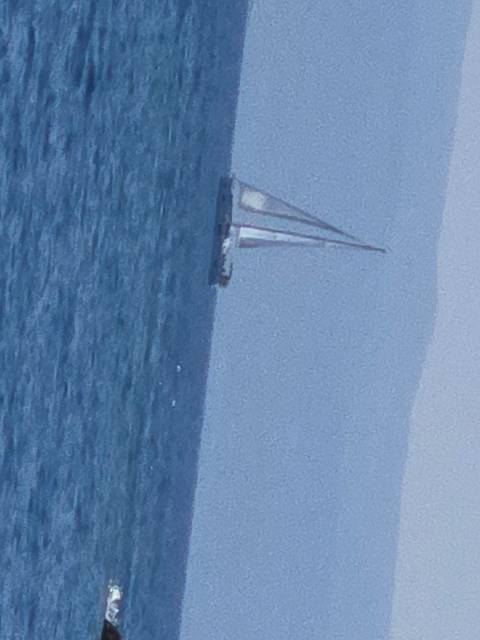 Sailboat tilted in the sea.