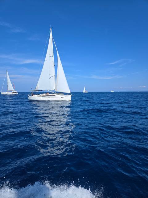Sailboat cruising on the open sea.