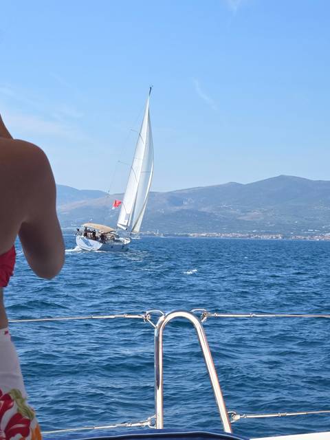 Sailboat on the water with mountains in the background.