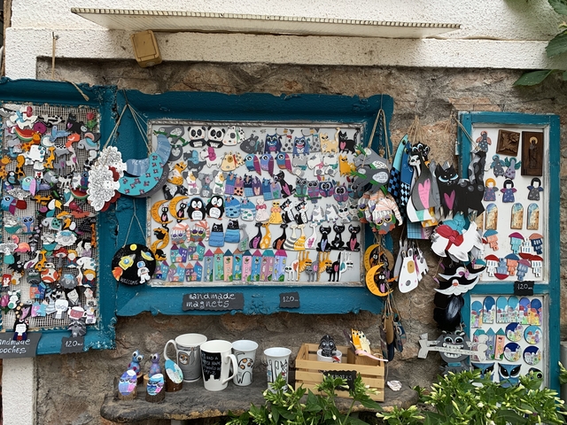       A display of colorful handmade magnets and crafts.
  