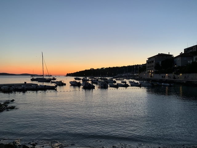 Serene sunset over a harbor with boats.