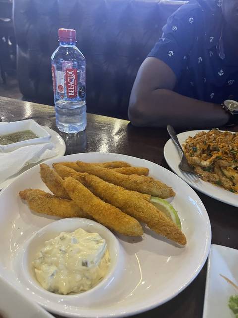Plate of fish sticks with sauce.