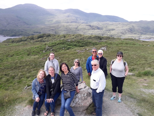      Group photo in a mountainous landscape.
  