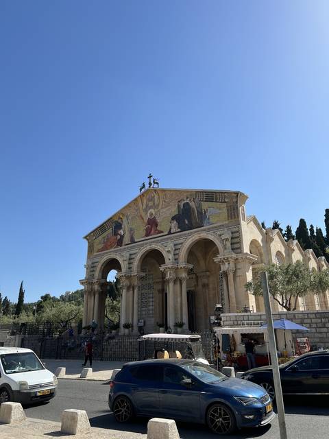       Facade of a church with mosaic and pillars.
  