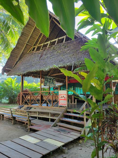 Open wooden structure in a green environment.