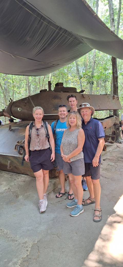       Group photo with military vehicle in forest area
  