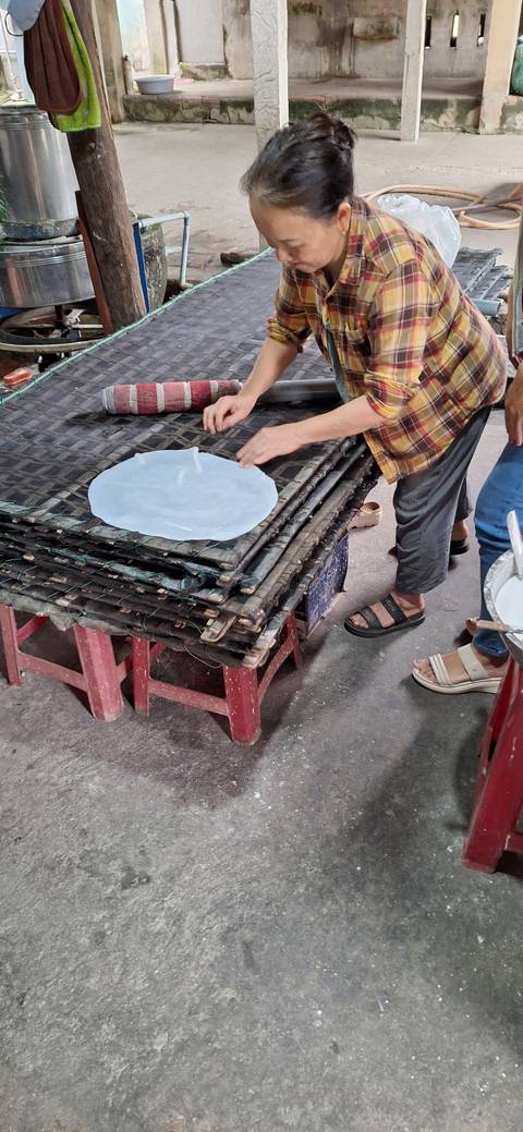Person making traditional food on a table