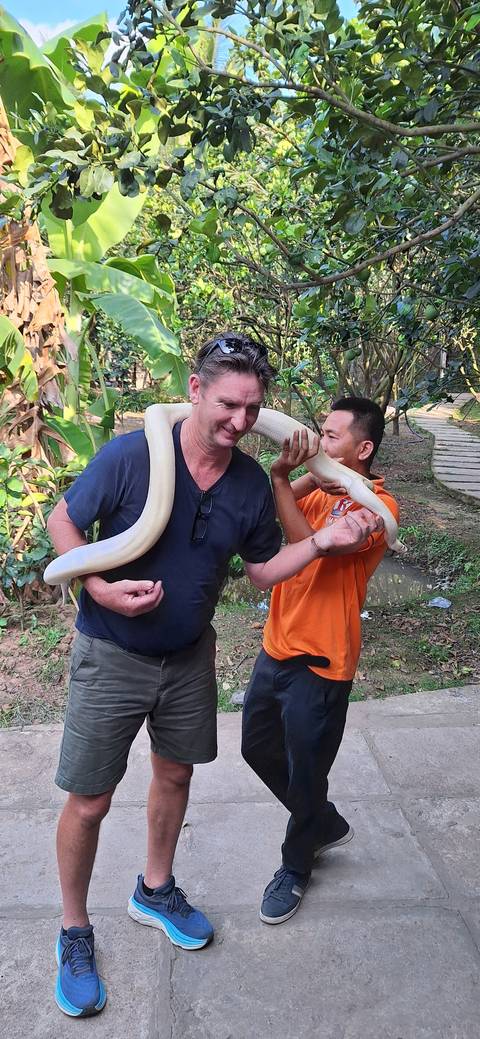 Person holding a snake with a guide