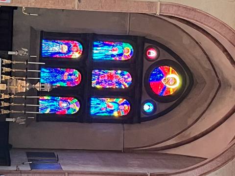 Stained glass windows in a church setting.
