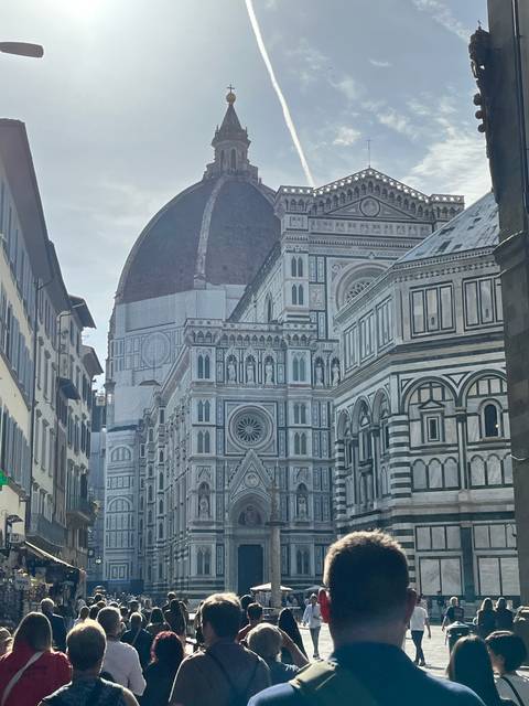 Exterior view of Florence Cathedral with people in the foreground.