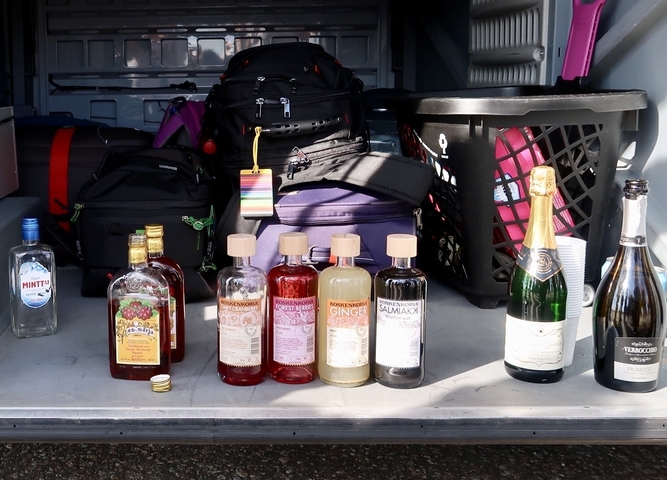 Various bottles of alcohol displayed in a vehicle.