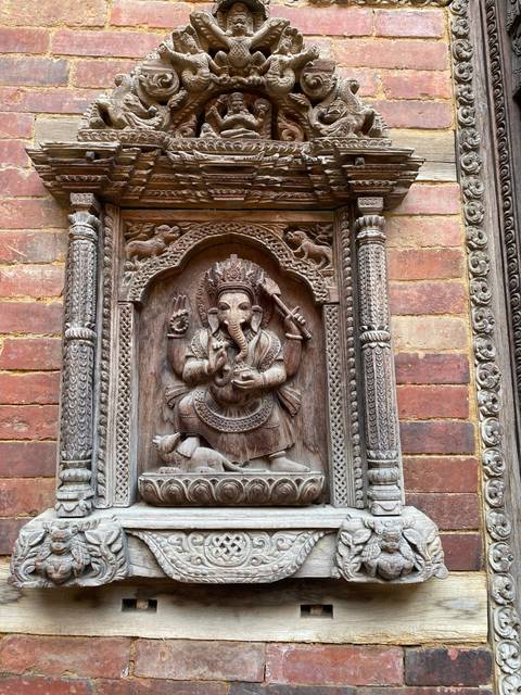 Carved wooden artwork depicting a figure.