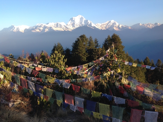       Colorful prayer flags against a backdrop of snow-capped mountains.
  