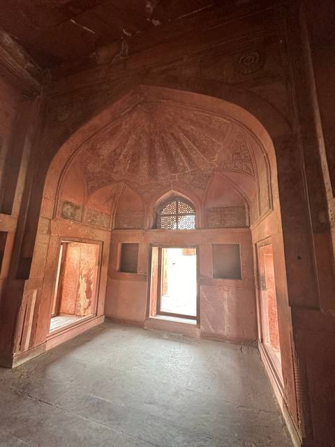 Interior of a building with windows and archway.