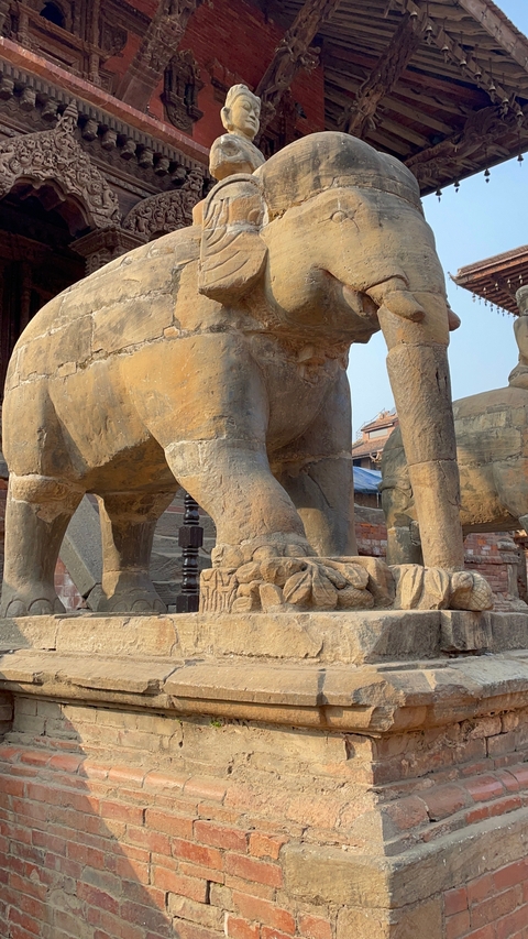 Close-up of stone elephant sculpture's legs.