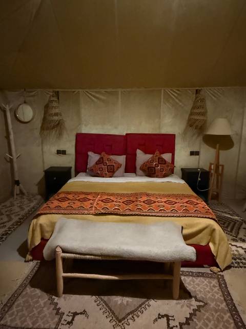 Room with a double bed and colorful decor.